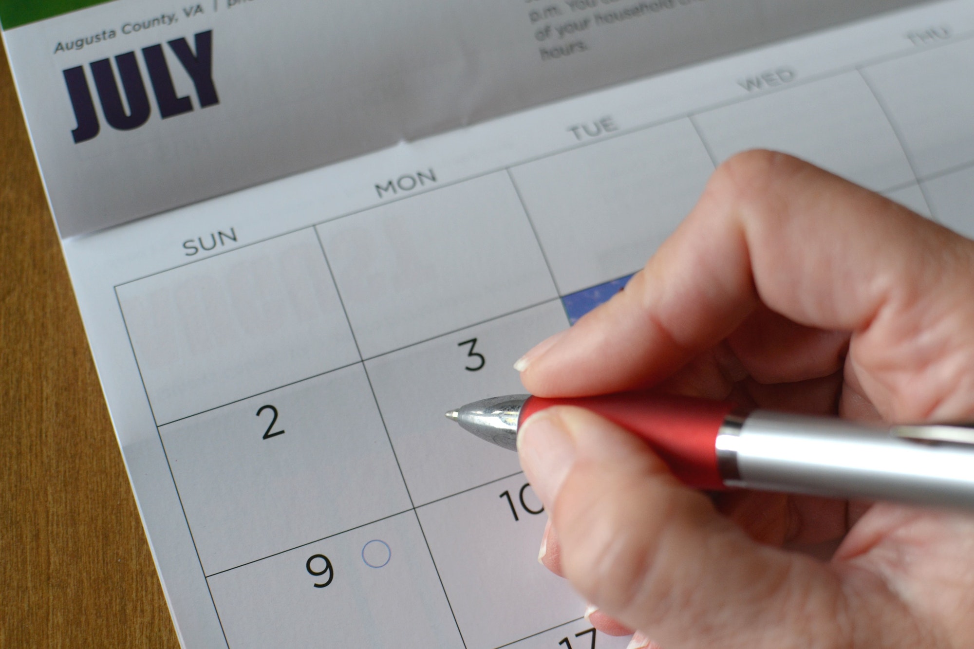 Writing appointments in a planner calendar.